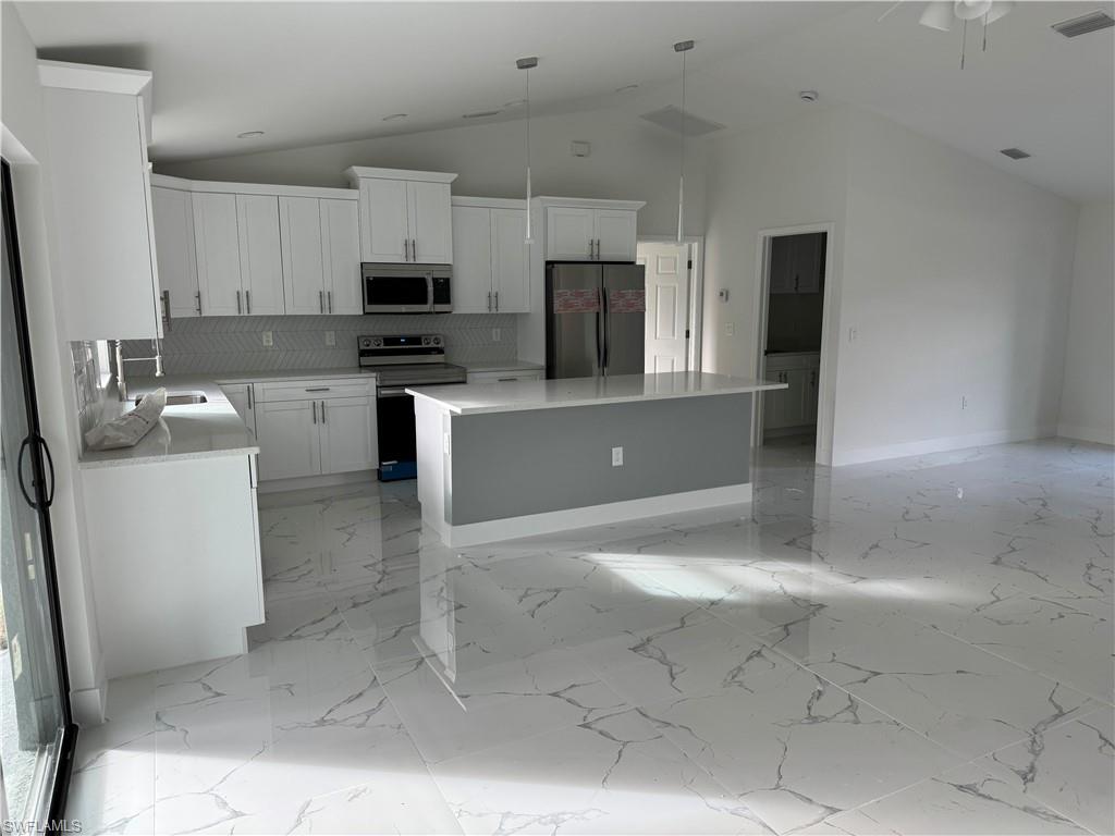 2530 Catron Circle Lehigh Acres, FL 33971 - Photo 9 of 27 a view of kitchen with microwave and cabinets