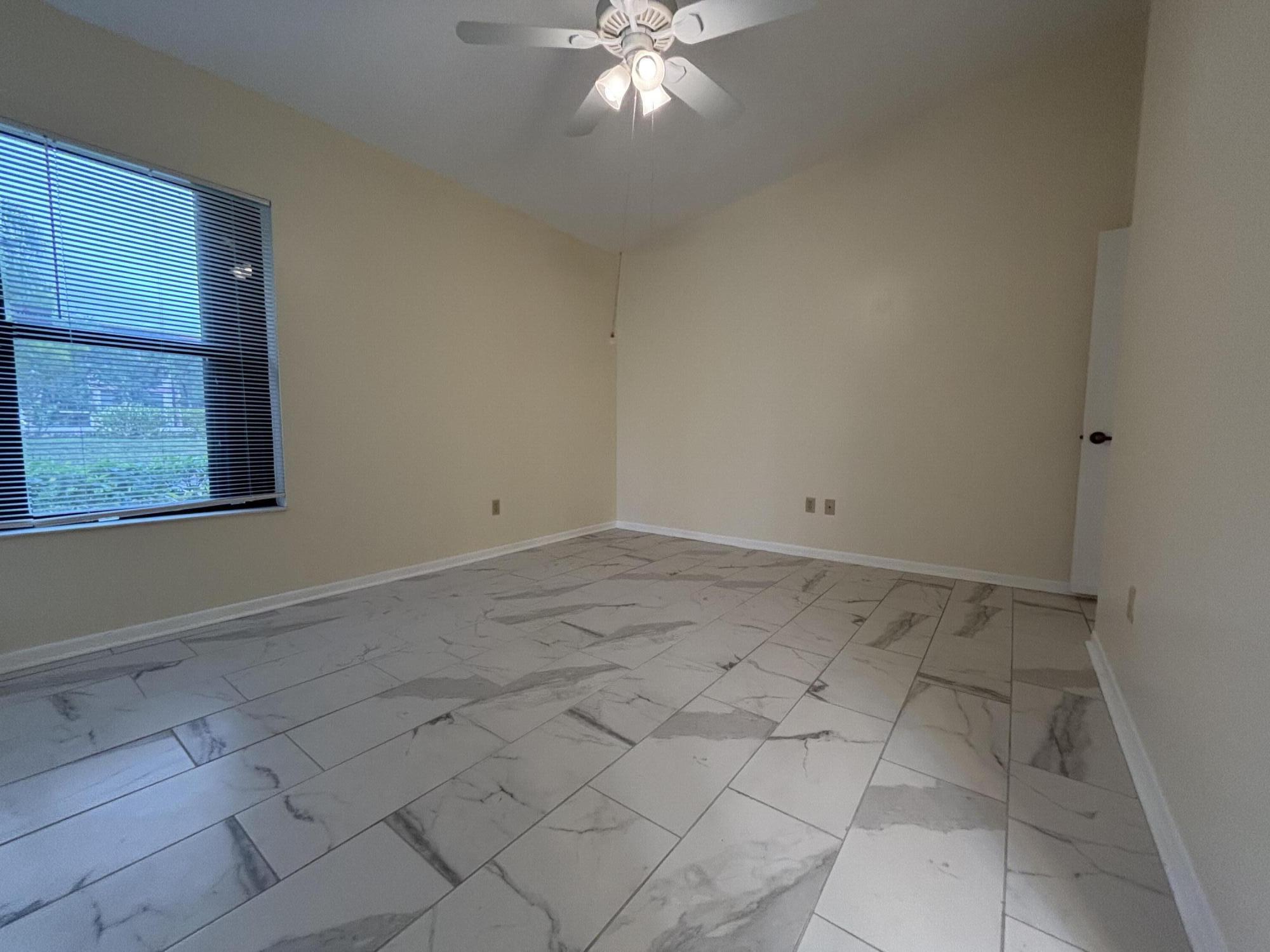 3872 Vine Trail, Unit D Lake Worth, FL 33467 - Photo 12 of 18 a view of an empty room with a window