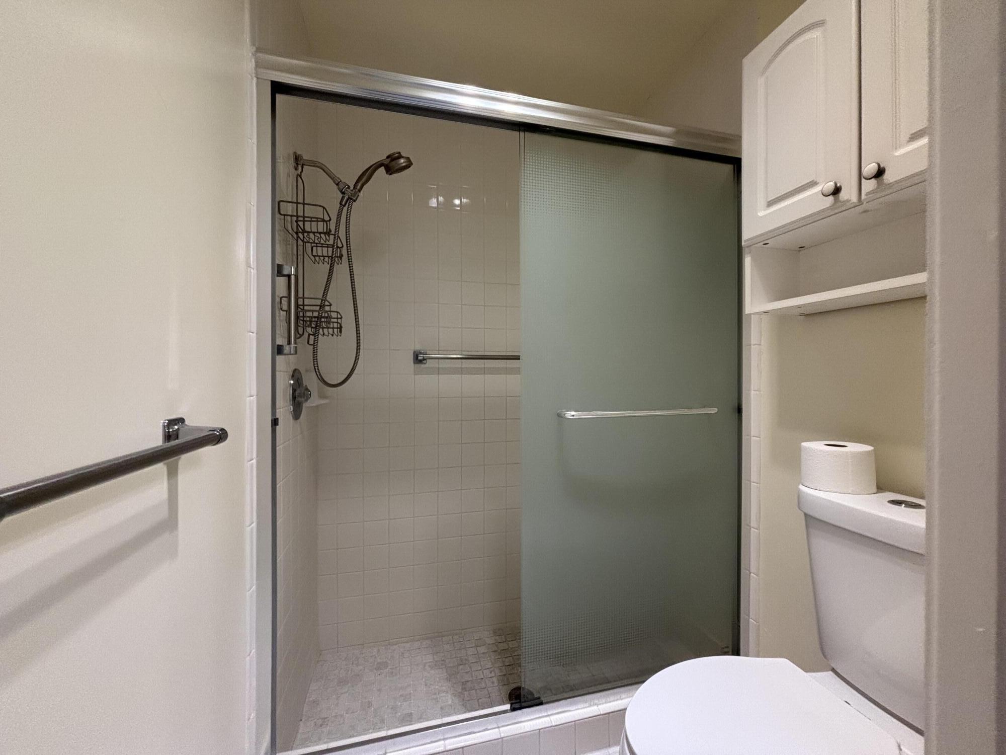 3872 Vine Trail, Unit D Lake Worth, FL 33467 - Photo 14 of 18 a bathroom with a shower and toilet
