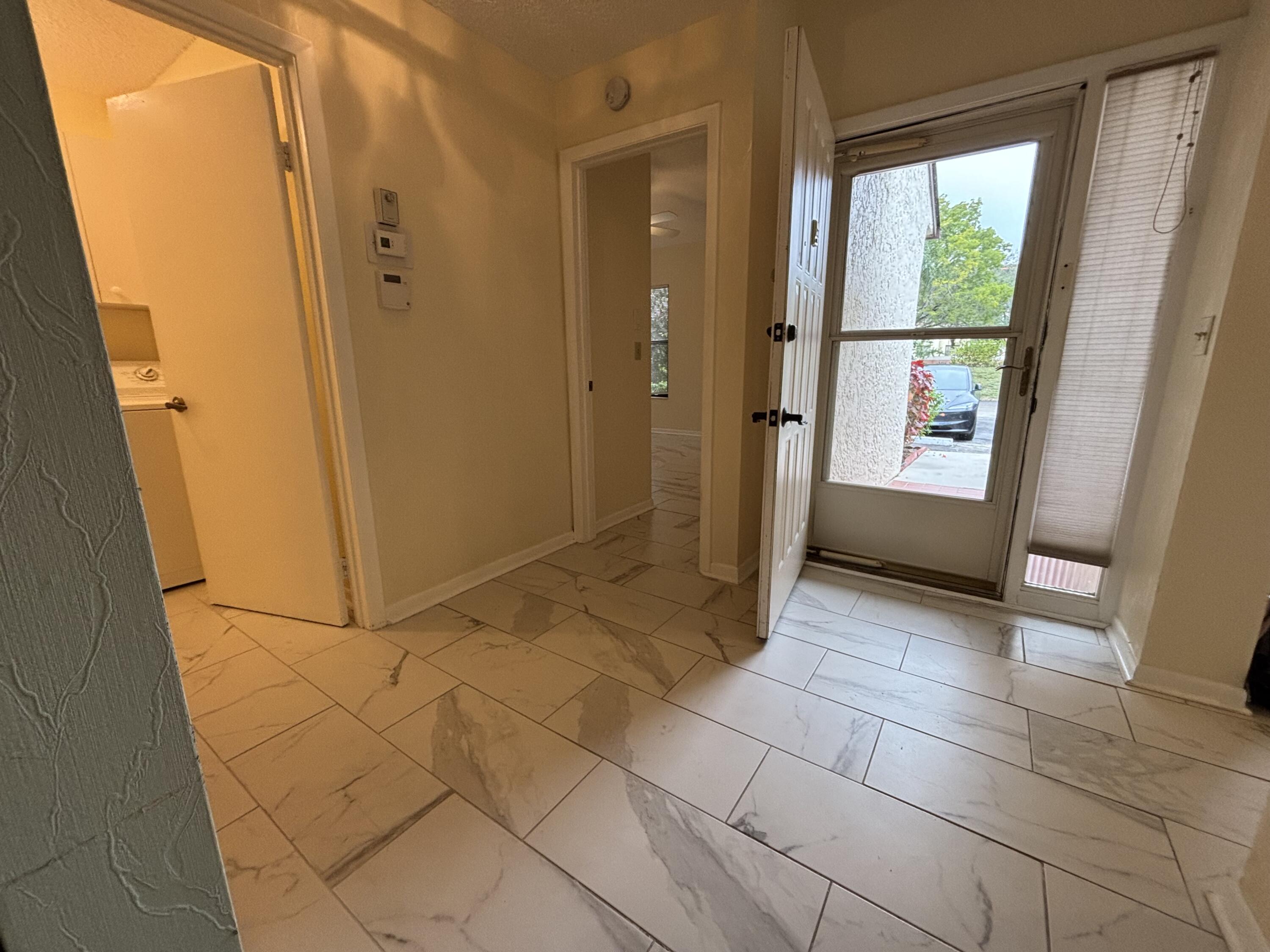 3872 Vine Trail, Unit D Lake Worth, FL 33467 - Photo 2 of 18 a view of entryway with window and front door