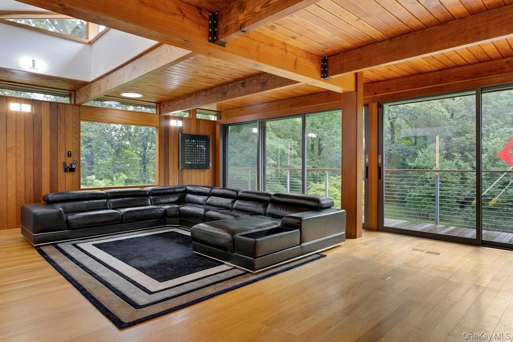 14 Cradle Rock Road East Pound Ridge, NY 10576 - Photo 7 of 34 Living room/Family room w/beamed ceiling and terrace w/electric shades. Room for a dining table as well.