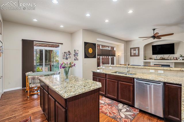 9709 Rockingham Drive Peyton, CO 80831 - Photo 13 of 50 Kitchen featuring stainless appliances, granite countertops, recessed lighting, ceiling fan, and a center island