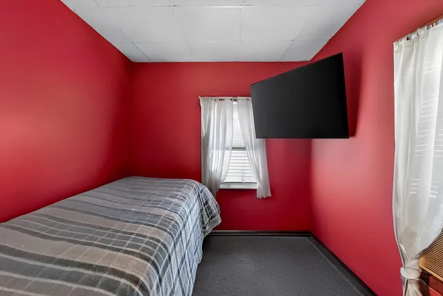 a bedroom with a bed and flat screen tv