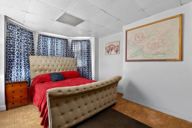 a bed sitting in a bedroom next to a window