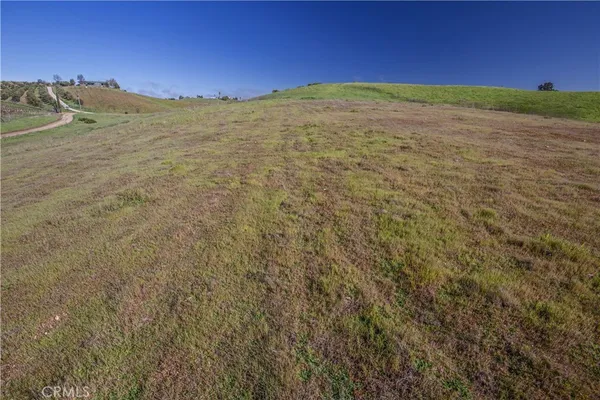 a view of a large building with mountains in the background