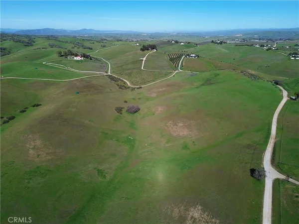 a view of a field with an ocean view
