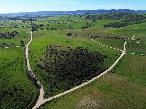 an aerial view of a golf course with a lake view
