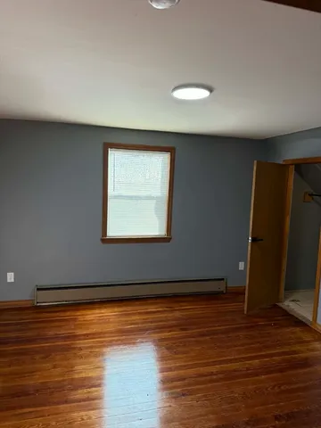 a view of a room with wooden floor