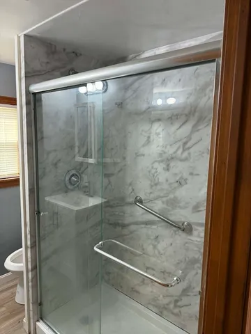 a bathroom with a glass shower door