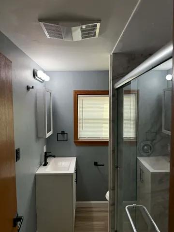 a bathroom with a sink a toilet and mirror