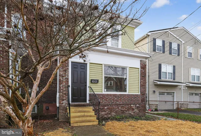 front view of a house with a tree