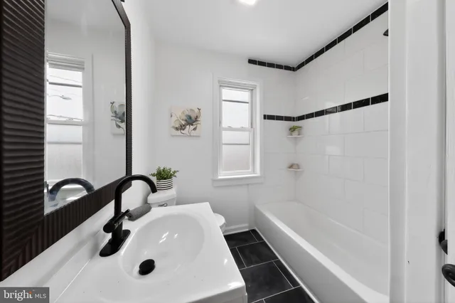 a view of a big room with wooden floor and windows