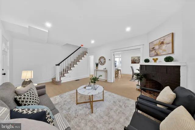 a living room with furniture and stairs