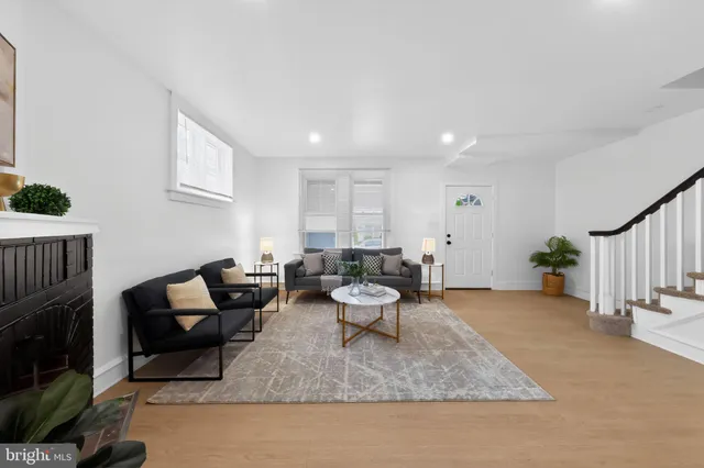 a living room with furniture a rug and a fireplace
