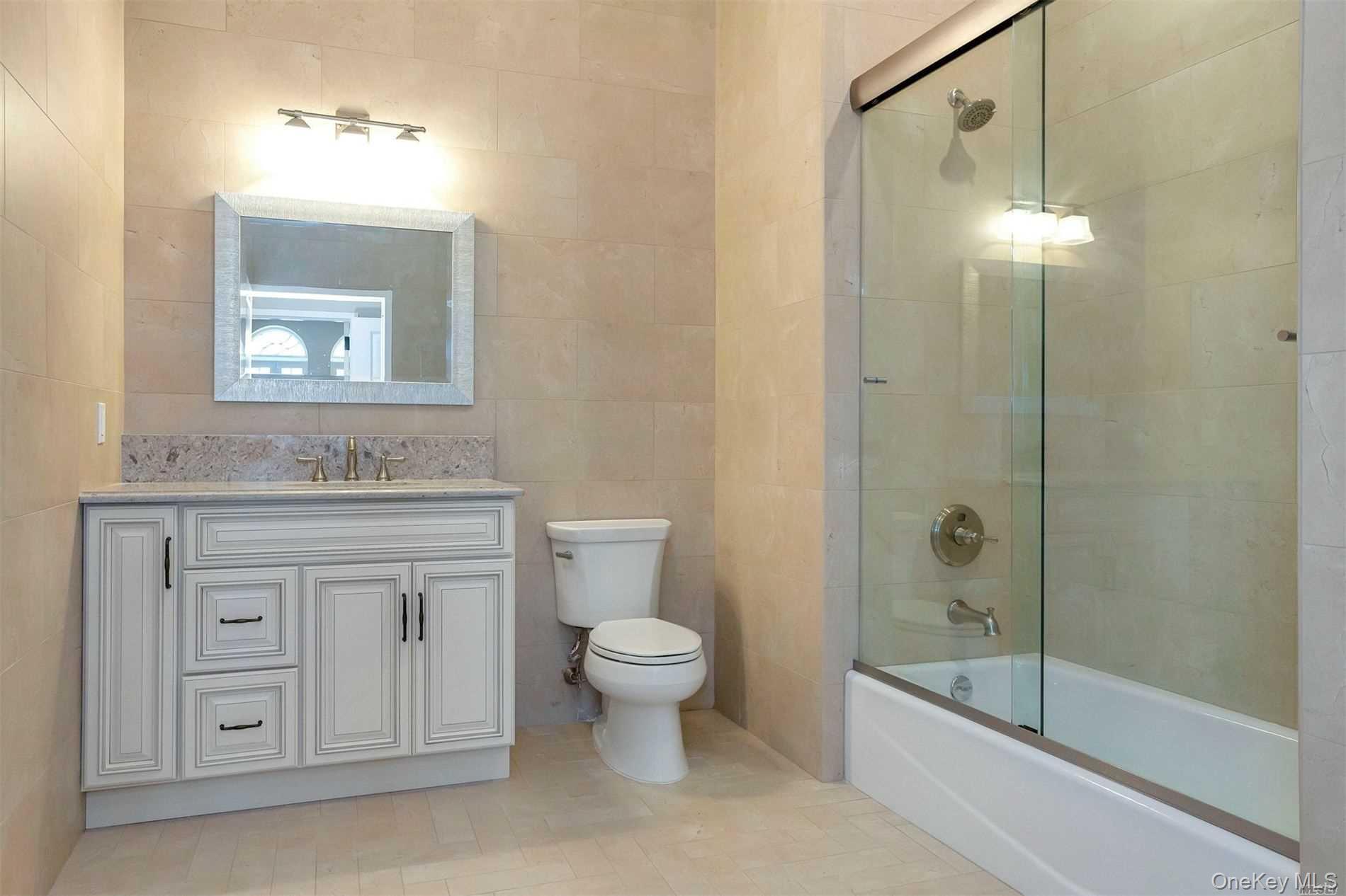 10 Wall Street, Unit 3A Huntington, NY 11743 - Photo 13 of 22 a bathroom with a granite countertop sink toilet and shower