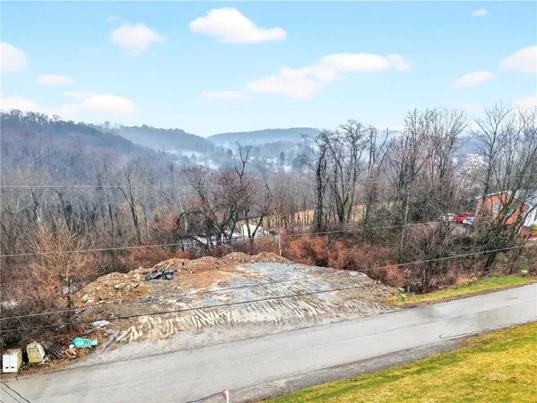 a view of a yard with mountains in the background