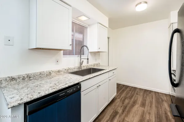 a kitchen with a sink and a refrigerator