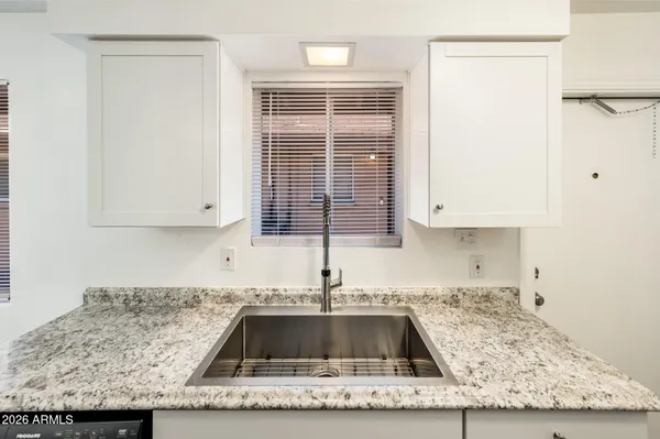 a kitchen with granite countertop a sink and a granite counter tops