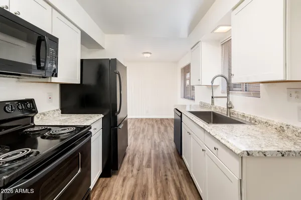 a kitchen with a sink stove and microwave