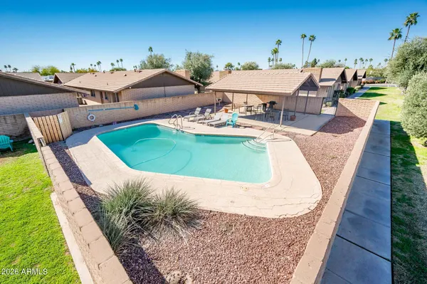 an outdoor space with pool and furniture