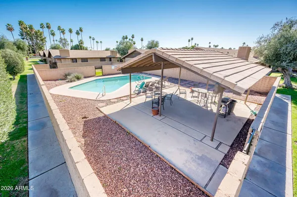 swimming pool view with a seating space