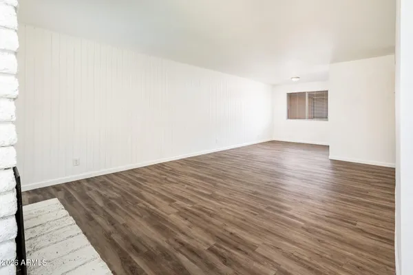 an empty room with wooden floor