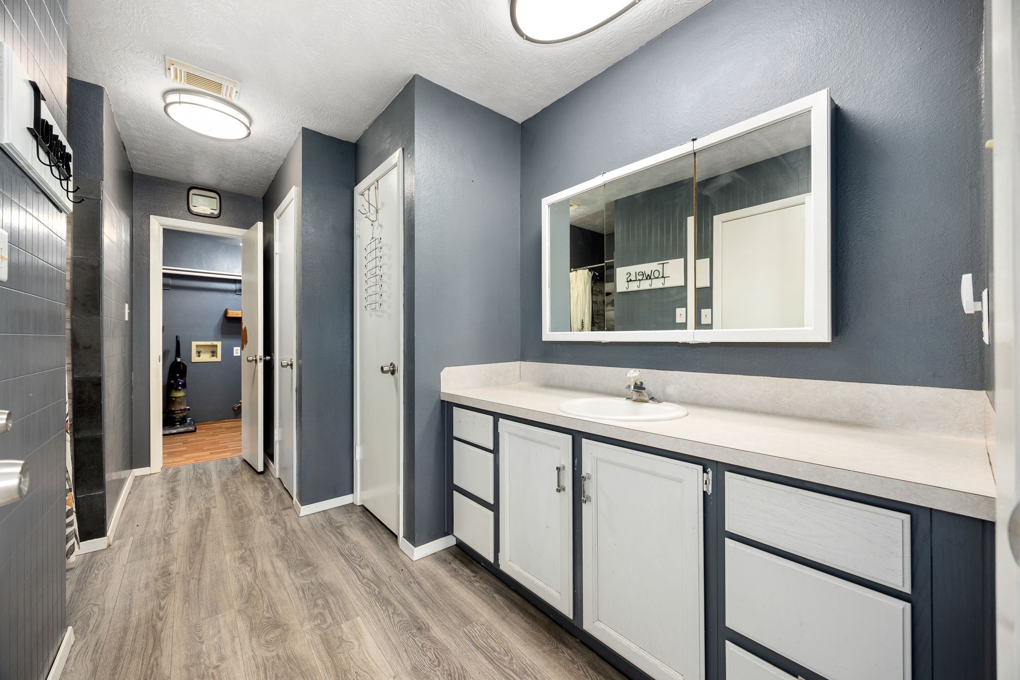 236 Pine Ridge Drive Cleveland, TX 77327 - Photo 9 of 22 Spacious primary bath with vinyl plank and custom tile shower