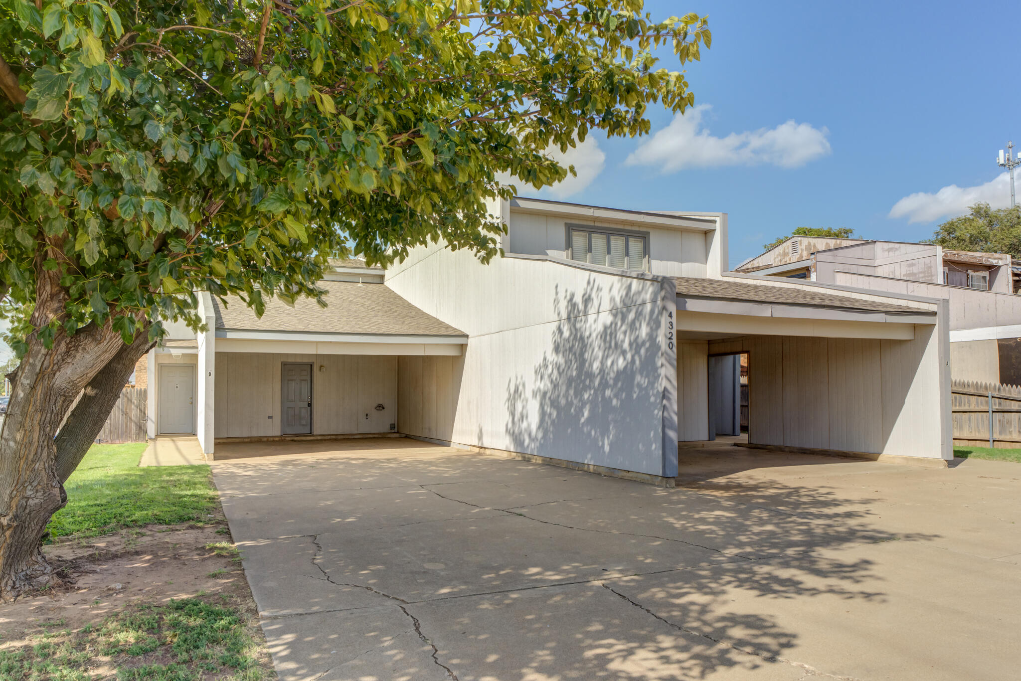 a front view of a house with a garden and yard