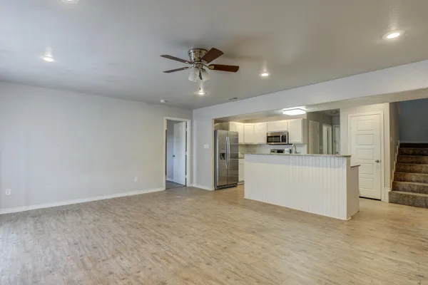 a view of a kitchen with a sink and a refrigerator