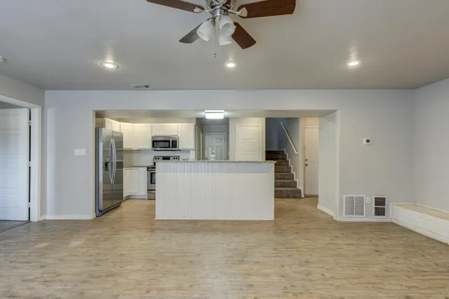 a view of a kitchen with a stove cabinets