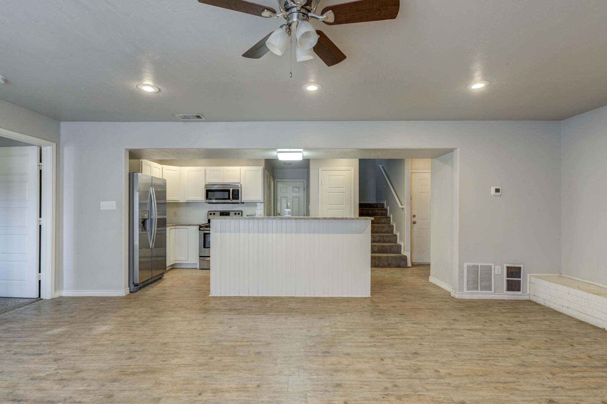 4320 52nd Street Lubbock, TX 79413 - Photo 13 of 59 a view of a kitchen with a sink and a refrigerator