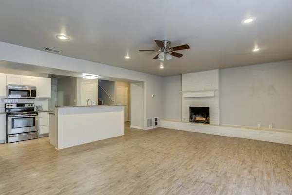 a view of an empty room with a fireplace