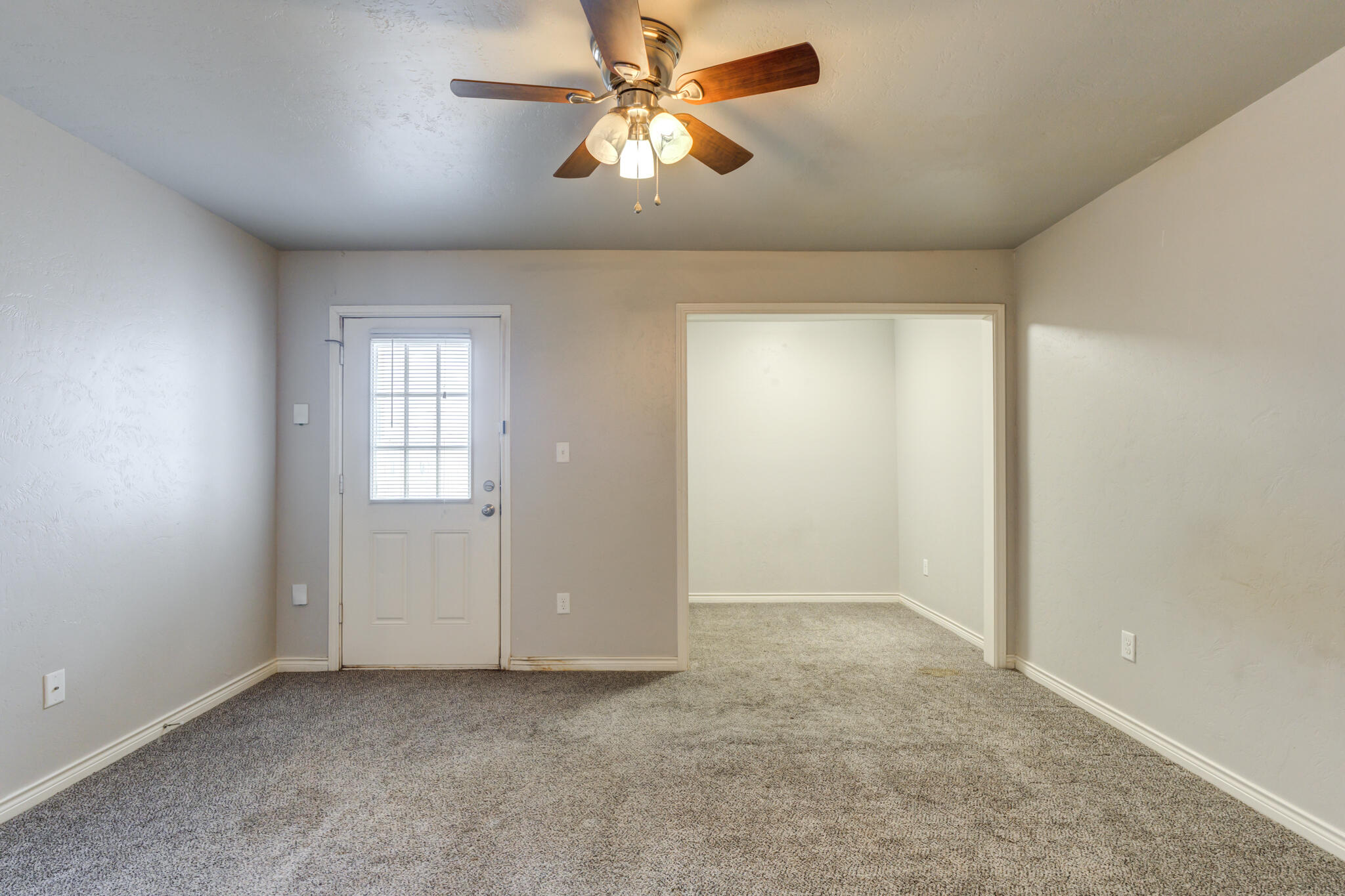 4320 52nd Street Lubbock, TX 79413 - Photo 17 of 59 an empty room with chandelier fan and windows
