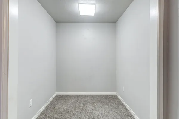 an empty room with cabinet and a bathroom
