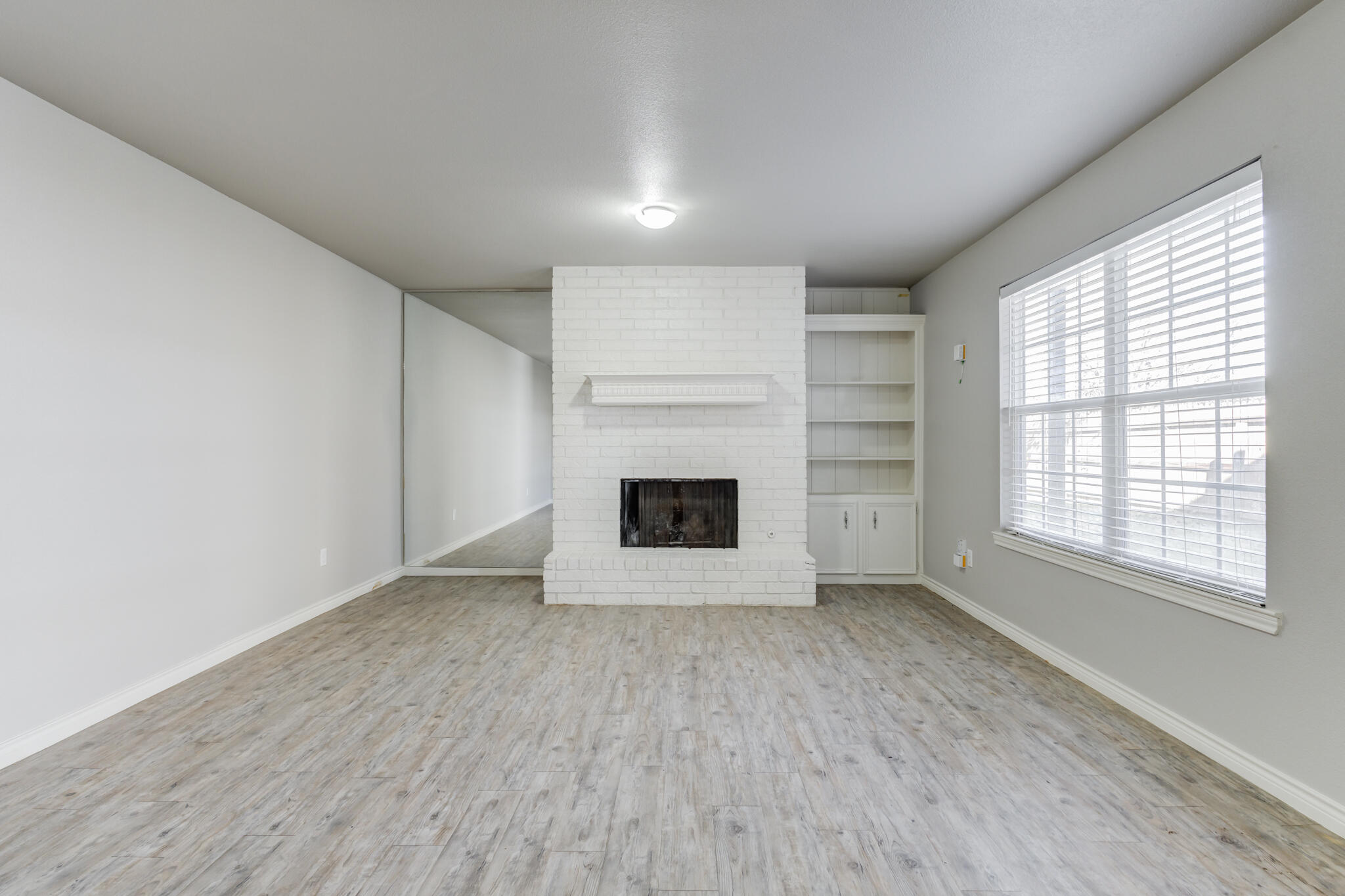 4320 52nd Street Lubbock, TX 79413 - Photo 36 of 59 an empty room with a fireplace and window