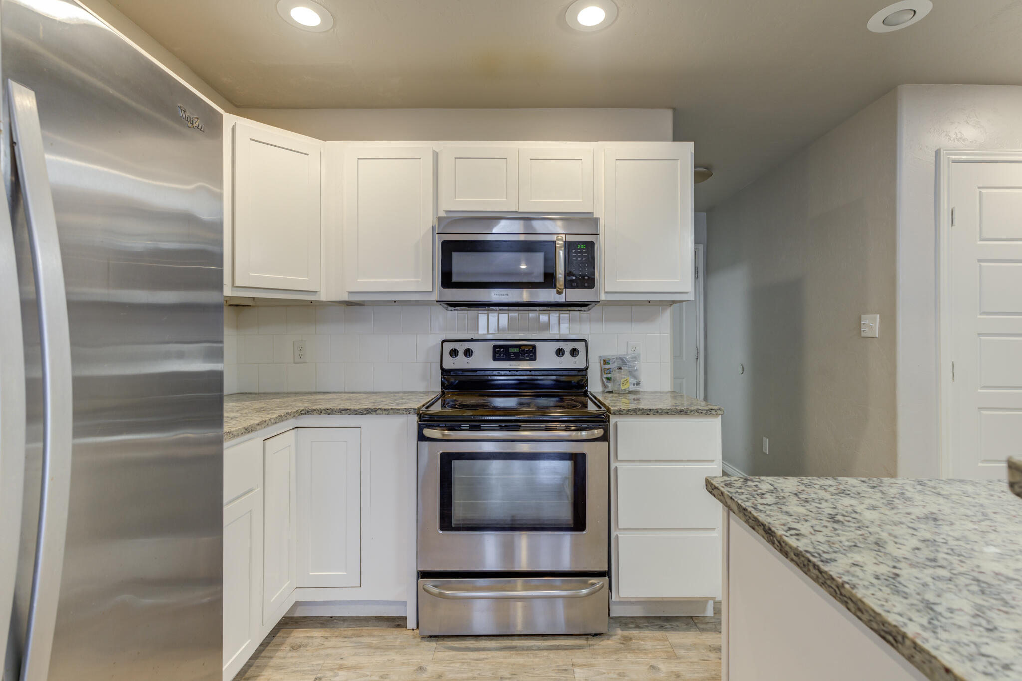 4320 52nd Street Lubbock, TX 79413 - Photo 8 of 59 a kitchen with granite countertop a stove and a sink