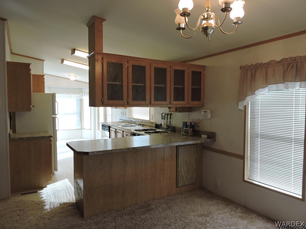4053 Cove Road Golden Valley, AZ 86413 - Photo 11 of 20 a kitchen with stainless steel appliances granite countertop a sink stove and refrigerator