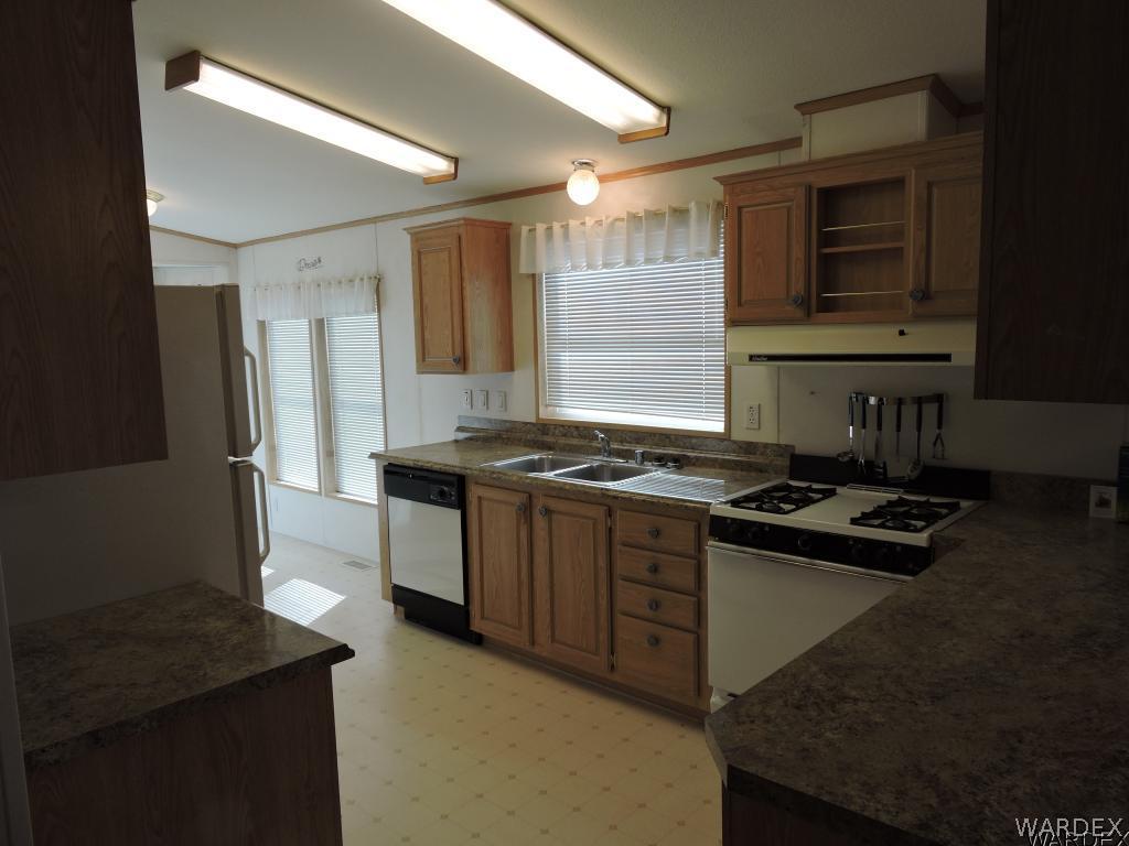 4053 Cove Road Golden Valley, AZ 86413 - Photo 12 of 20 a kitchen with stainless steel appliances granite countertop a stove and a refrigerator