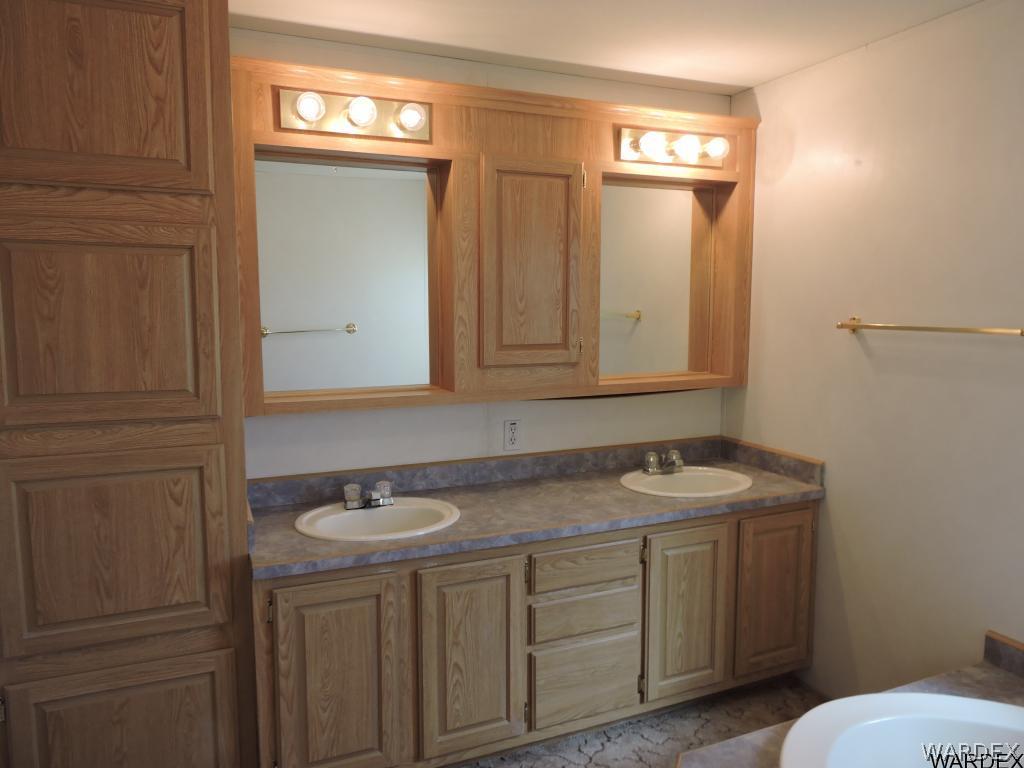 4053 Cove Road Golden Valley, AZ 86413 - Photo 16 of 20 a bathroom with a sink and a mirror
