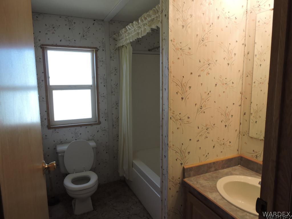 4053 Cove Road Golden Valley, AZ 86413 - Photo 18 of 20 a bathroom with a sink and a toilet