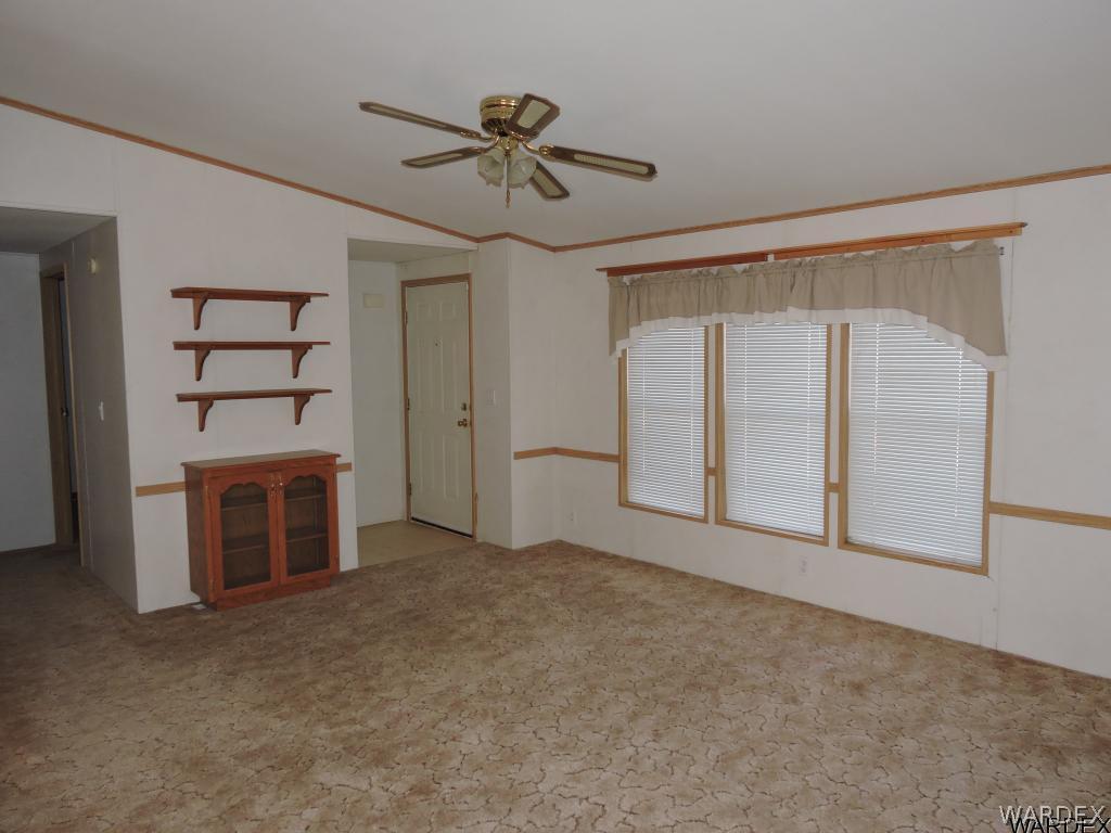 4053 Cove Road Golden Valley, AZ 86413 - Photo 6 of 20 a view of an empty room with a fireplace and a window