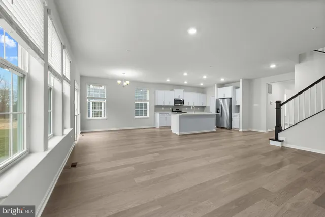 a view of kitchen with refrigerator and window