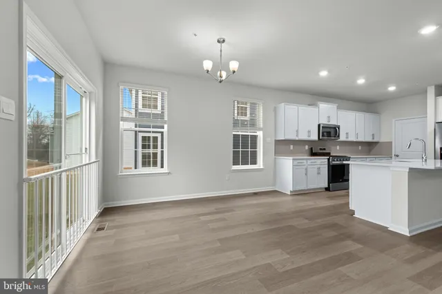 a view of a kitchen with granite countertop stainless steel appliances and window
