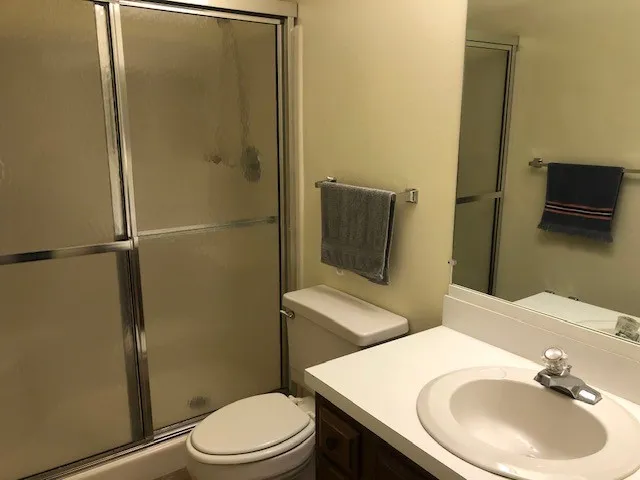 a bedroom with two beds and a lamp