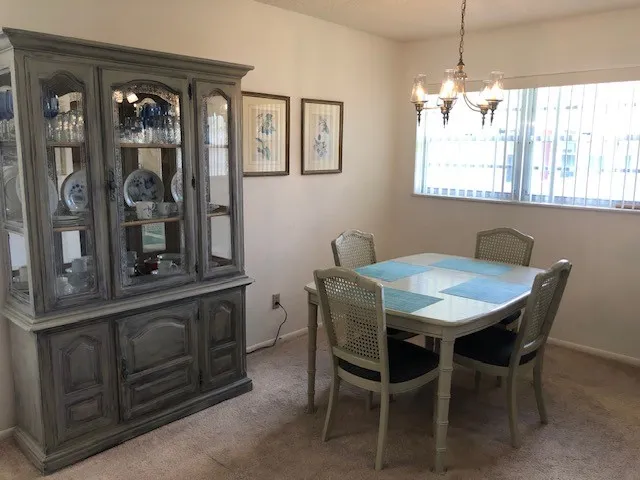 a view of a dining room with furniture and window