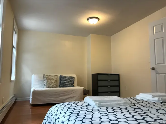 a bedroom with a bed and a couch