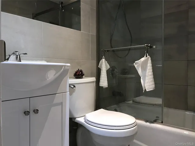 a white toilet sitting next to a bathroom sink