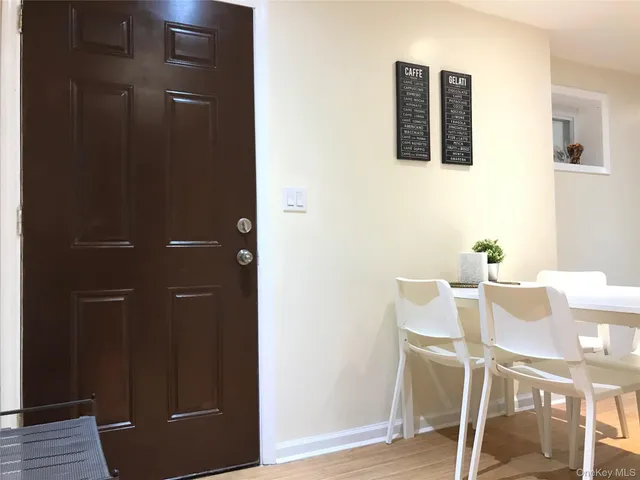 a dining room with furniture and wooden floor