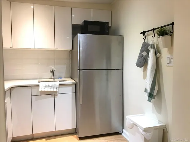a white refrigerator freezer sitting inside of a kitchen