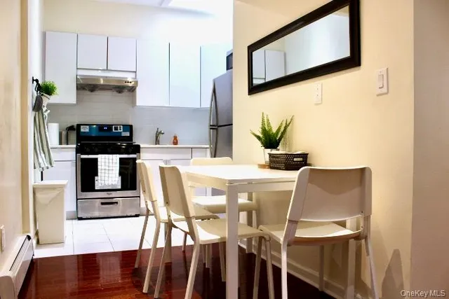 a kitchen with stainless steel appliances kitchen island granite countertop a refrigerator and microwave